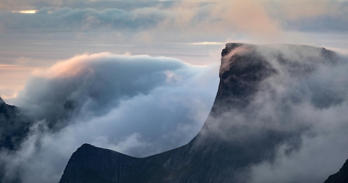 A misty mountain peak shrouded in fog